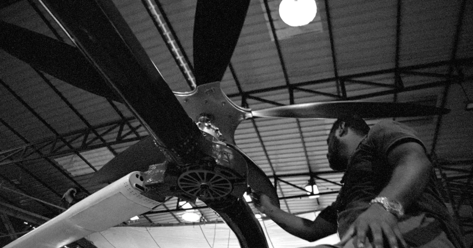 An engineer working on the EP3F propeller beneath the wing